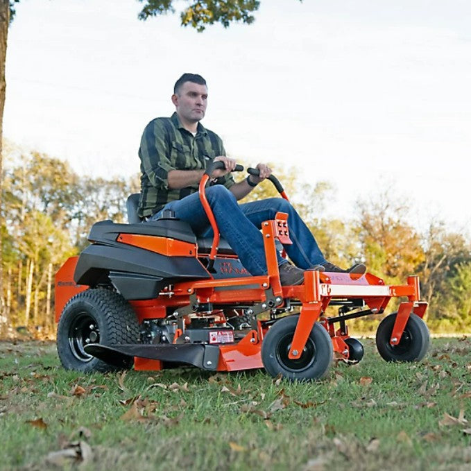 Man operating a riding lawn mower in an outdoor setting with trees and grass.