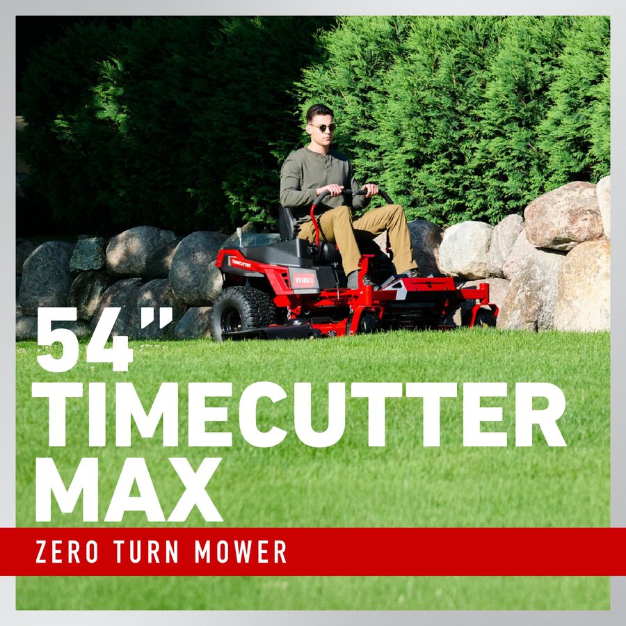 Person using a 54” Timecutter Max zero turn mower in a grassy area with rocks and trees.

