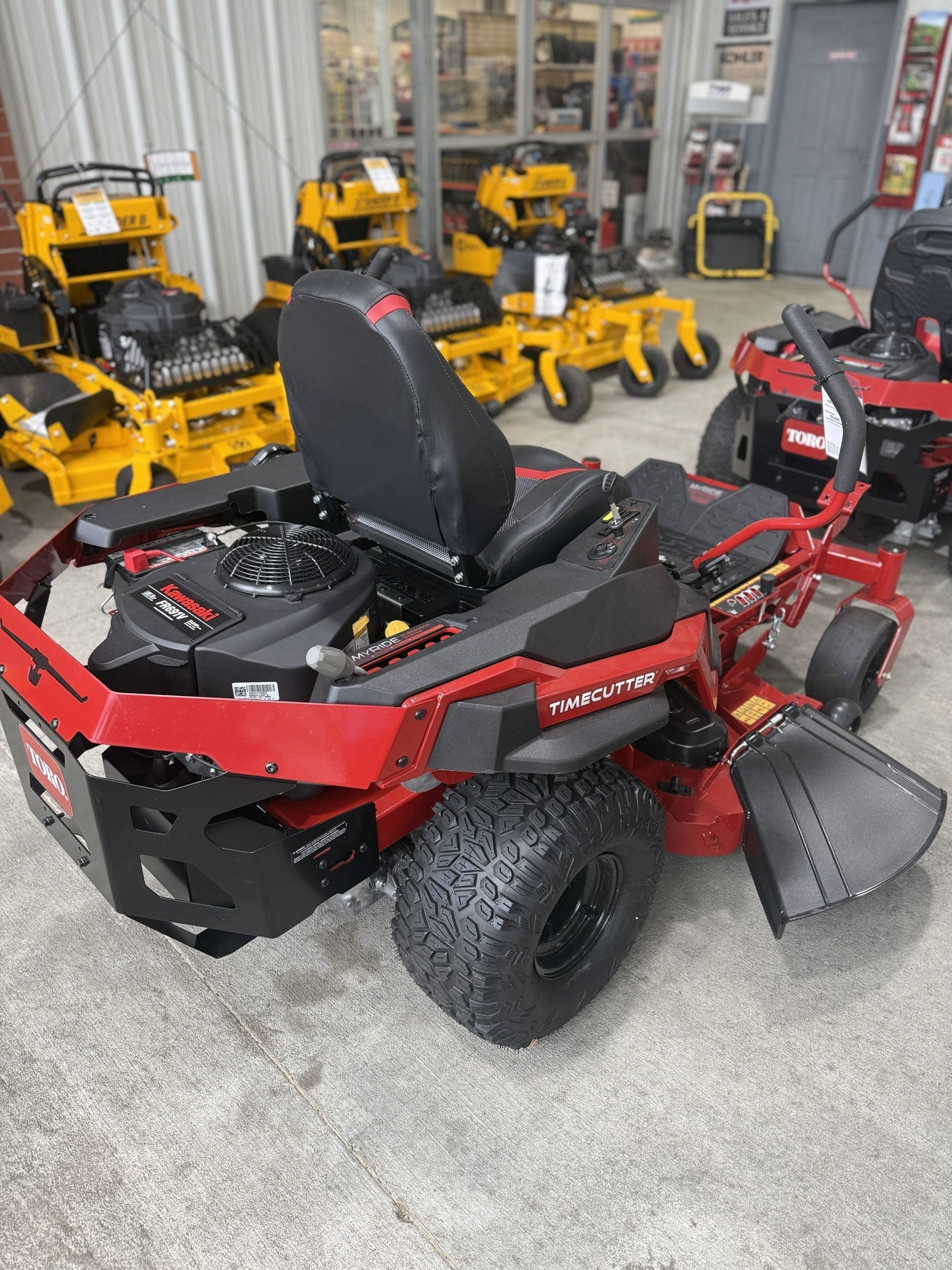 Red and black zero-turn lawn mower in a showroom setting

