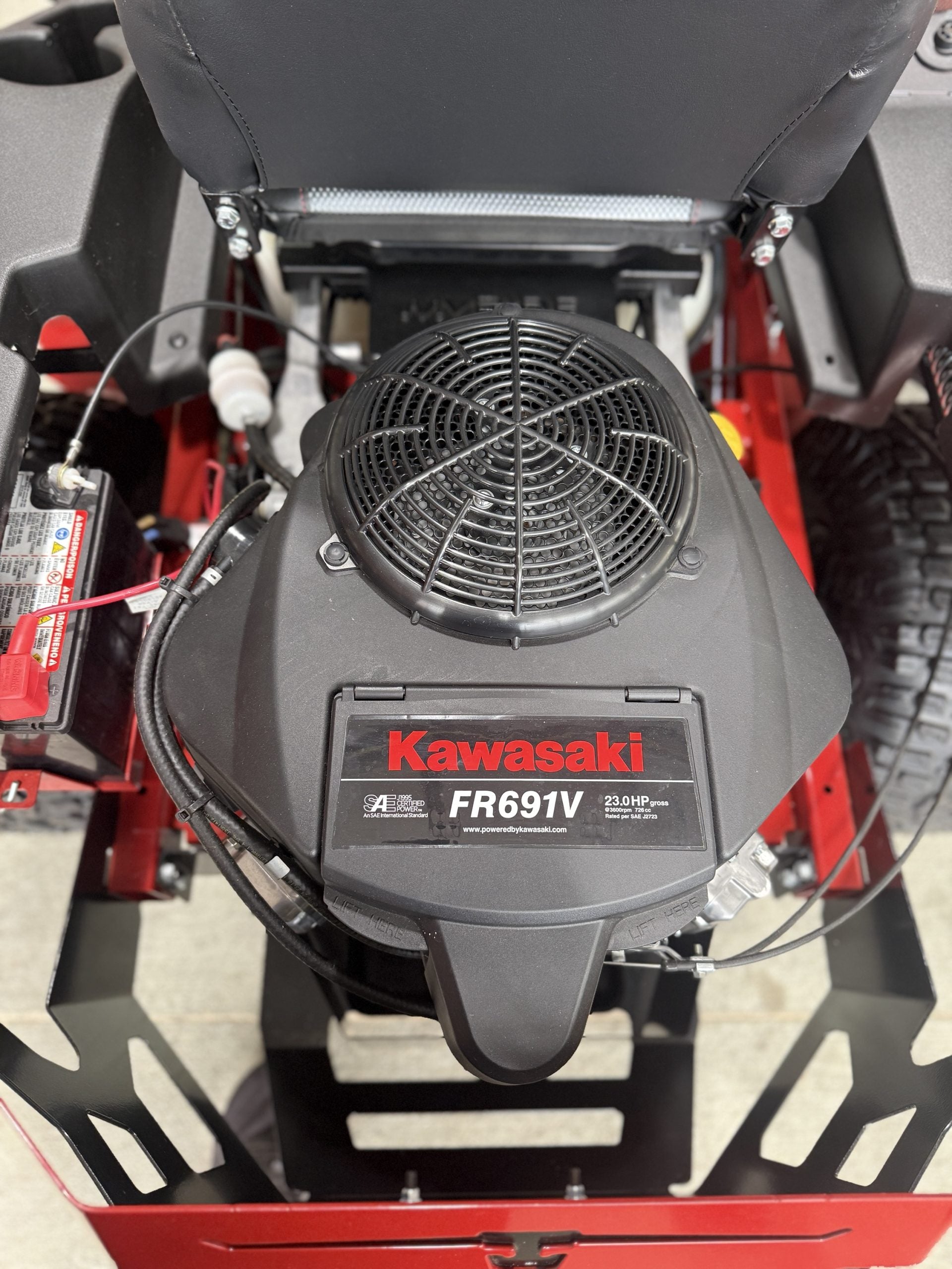 Kawasaki engine on a piece of machinery with a red and black color scheme.

