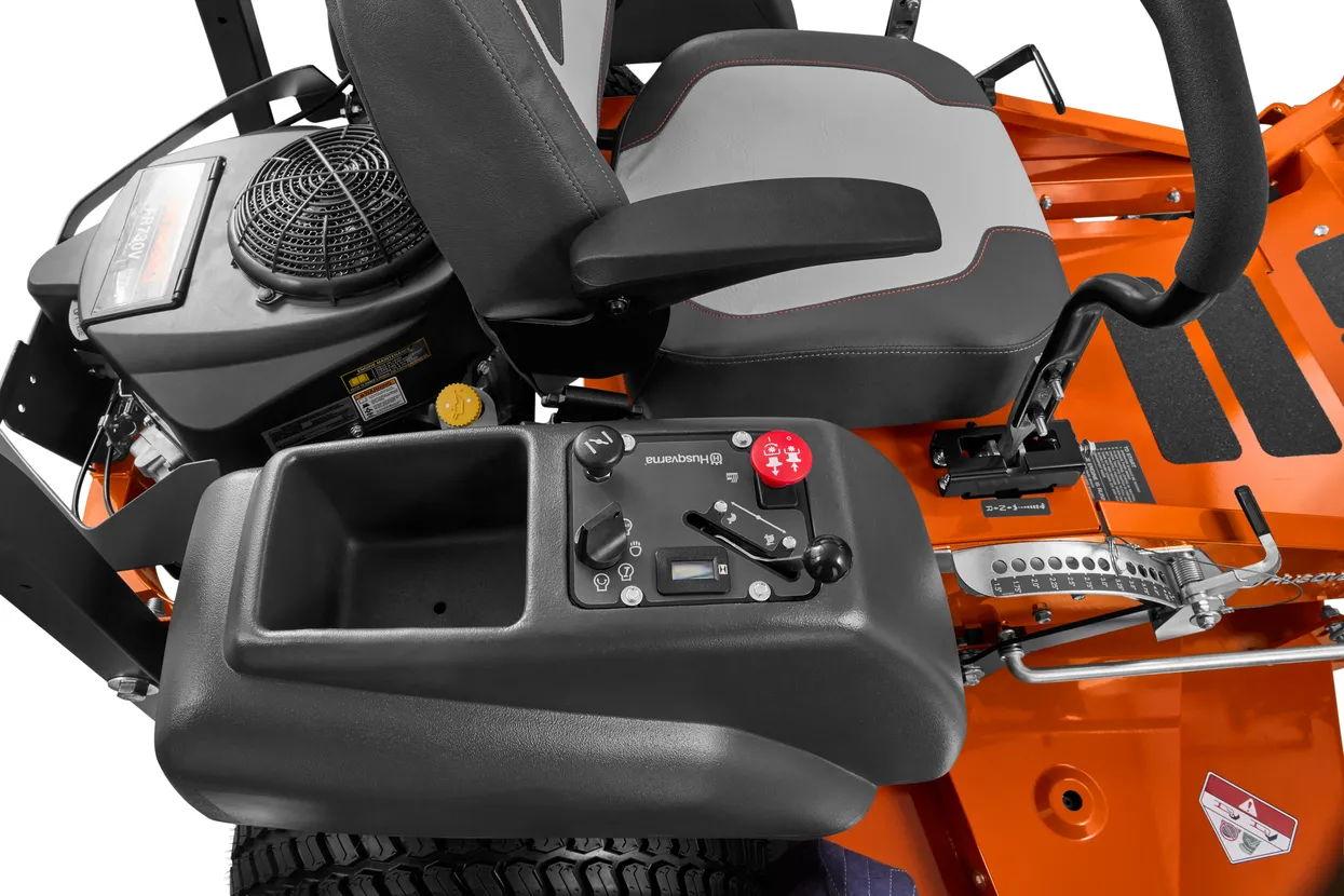 Close-up of a lawn mower's seat and control panel with visible brand logo.

