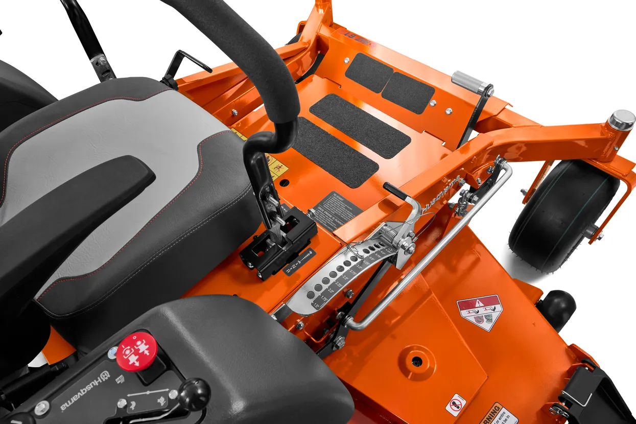 Close-up of an orange lawn mower with black seat and visible brand logo.

