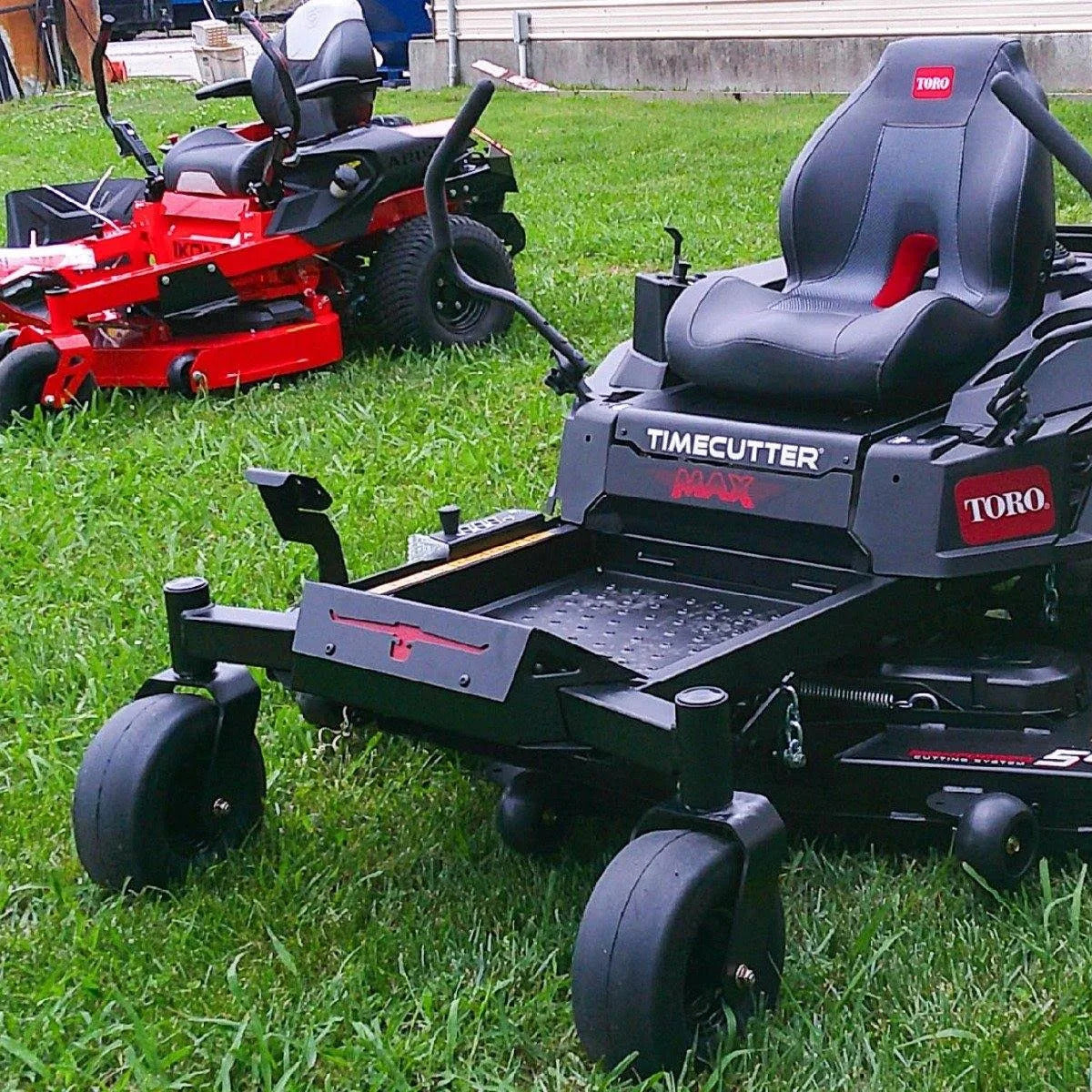 Two riding lawn mowers on a grassy area, with one prominently displayed in the foreground.


